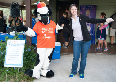 Chick-fil-a Cow and Young Woman Posing for a Picture