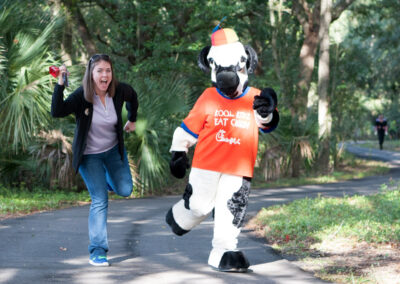 Woman and the Chick-fil-a Cow Staging their Running Motion