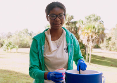 Girl Smiling as She Serves a Drink